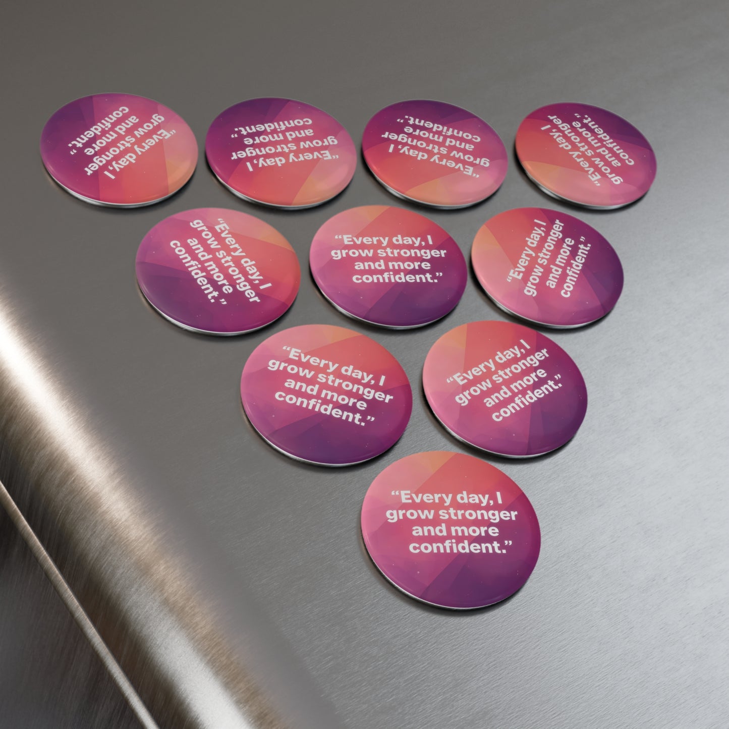 Motivational stickers with affirmations on a metallic surface