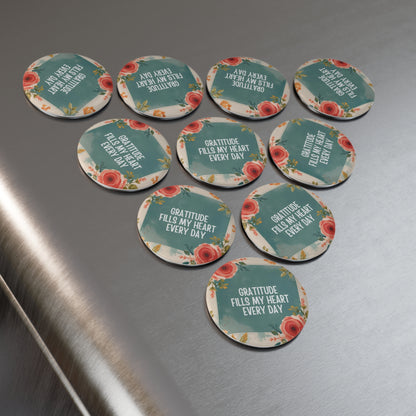 Set of round Pins with motivational phrases on a metallic surface
