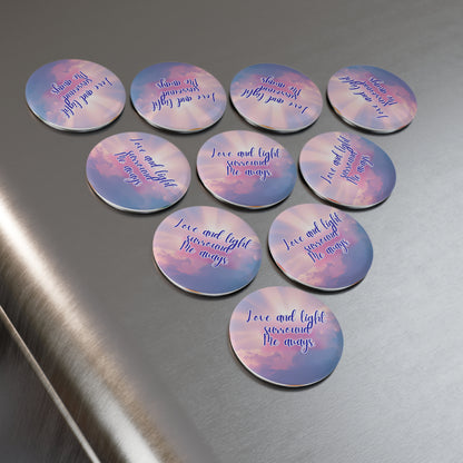 Set of circular pins with motivational phrases on a metallic surface