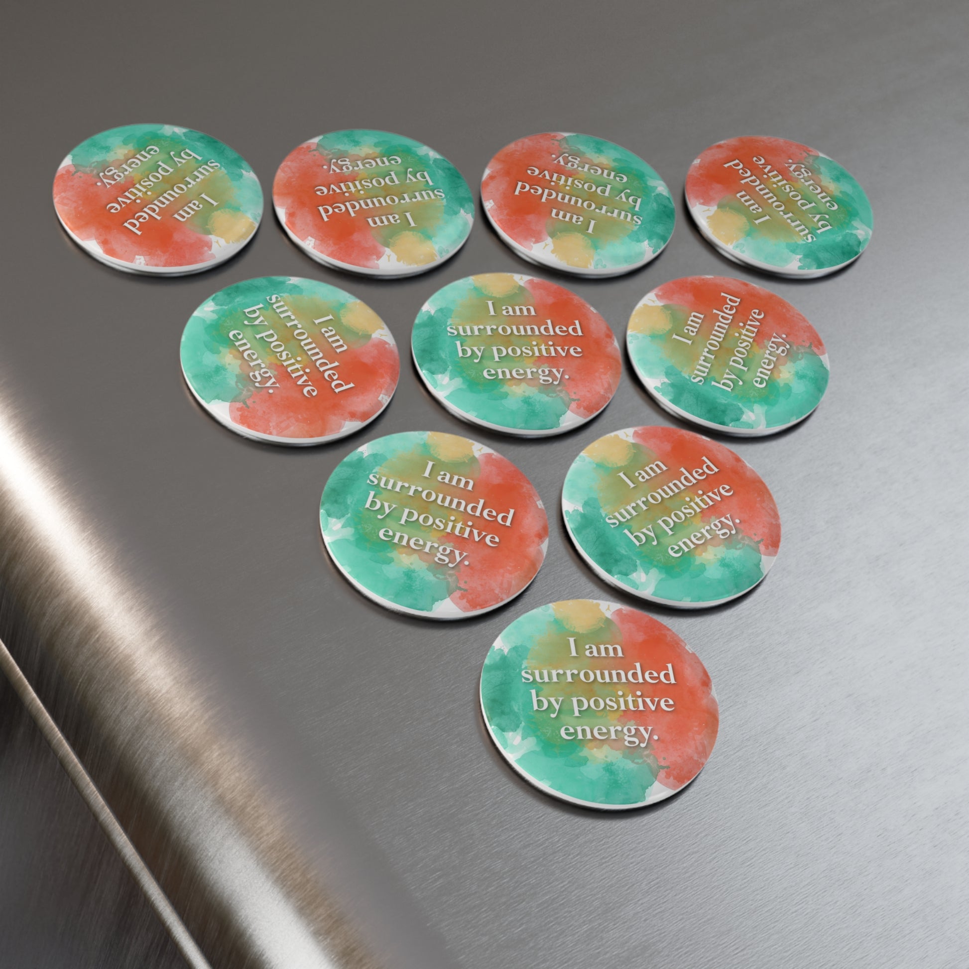 Circular stickers with motivational phrases on a metallic surface